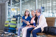 © Akarawut - Group of Asian family tourist passengers with senior is using mobile application to call pick up taxi at the airport terminal for transportation during the vacation travel and long weekend holiday
