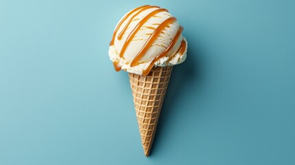 Delicious ice cream cone with caramel drizzle on a blue background.