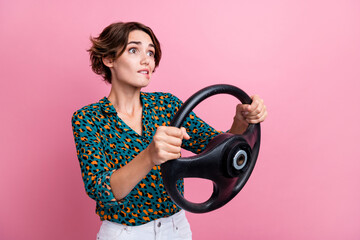 Sticker - Portrait of nervous girlish woman wear print blouse hold steering wheel look at crash empty space isolated on pink color background