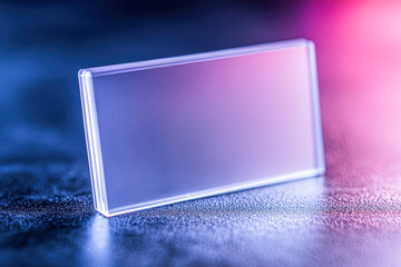 A clear plastic square sits on a dark surface