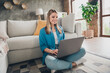 © deagreez - Photo of young homey girl in casual outfit trying find freelance job going to interviews at home using just laptop indoors modern design living room