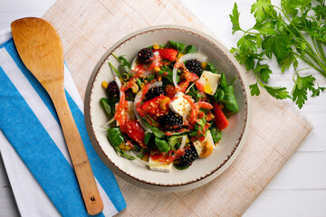 Healthy red berry and brie salad. Top view table with  decorations.