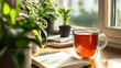 © Sianfood - 20240929200304list 16 A minimalist home office setup with a cup of herbal tea, an open notebook, and a plant by the window, representing a calm and mindful work environment