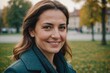 © ThomasLENNE - Close portrait of a smiling 40s Romanian woman looking at the camera, Romanian outdoors blurred background