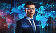 © Miklos - A businessman stands before a digital world map, representing global reach and connection