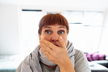 portrait middle-aged woman sneezing, coughing, covering her mouth with her hand,