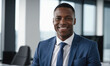 © Miklos - A businessman smiles confidently in a modern office setting