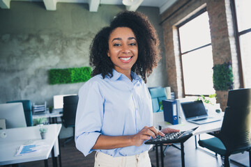 Canvas Print - Photo of cheerful positive lady recruiter dressed shirt holding calculator indoors workplace workstation loft