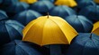 © Tyoma - A yellow umbrella is placed in front of a group of blue umbrellas