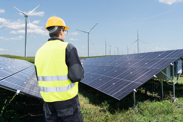 Poster - Engineer with digital tablet on a background of solar panels
