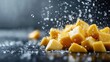 © familymedia - The close-up image of diced fruit in motion evokes energy and vitality, with sharpness and vibrancy contrasted against a deep, dramatic background.