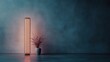 © familymedia - A contemporary vertical floor lamp stands beside a decorative plant, casting warm ambient light against a textured blue wall, embodying modern elegance and tranquility.
