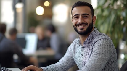 Aufkleber - Smiling young middle eastern businessman sitting at worktable at modern office typing on computer keyboard sending emails to his business partners working on marketing research copy sp : Generative AI