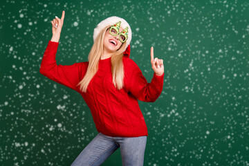 Wall Mural - Portrait of attractive cheerful carefree girl dancing having fun winter day isolated over green color background