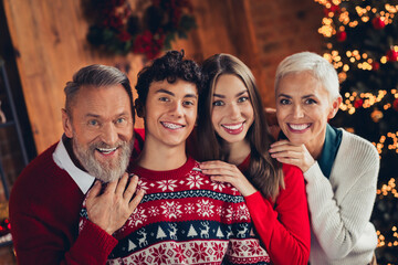 Canvas Print - Photo of happy smiling family grandfather grandmother cuddle grandson granddaughter in new year style house