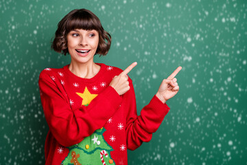 Sticker - Photo of shiny excited young woman dressed red pullover smiling pointing looking empty space isolated green color background