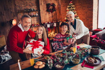 Wall Mural - Photo of peaceful family sit table giving giftbox celebrate festive christmas time apartment indoors