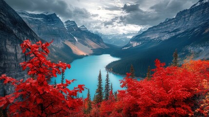 Wall Mural - A breathtaking view of a mountain lake with red foliage in the foreground and a cloudy sky overhead.