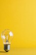 © ArtCookStudio - A vintage light bulb placed against a vibrant yellow background for aesthetic appeal