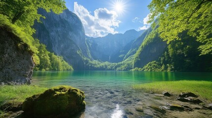 A serene mountain lake with crystal clear water surrounded by lush greenery and majestic mountains under a bright sunny sky.