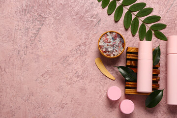 Wall Mural - Bottles and jars of cosmetic products with sea salt on pink background