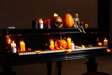 Wall Mural - Grand piano with burning candles and Halloween decor in dark room