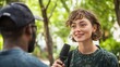 © gn8 - Diverse Outdoor Interview, Young Woman with Curly Hair Interviewing Man, Green Park Setting