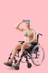 Poster - Male swimmer in wheelchair on pink background