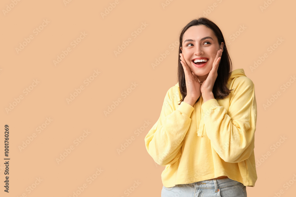 Smiling young woman on brown background