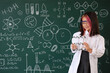 © Pixel-Shot - Cute little girl with molecular model near chalkboard at chemistry lesson in classroom