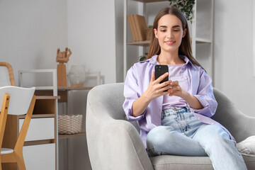 Sticker - Young beautiful woman chatting with mobile phone on armchair at home