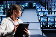 © DC Studio - Trained engineer preparing server mainframes contingency plan, monitoring data center energy consumption across components, making sure sensors are functioning properly, doing routine disk checks