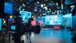 © Elmira - The bustling television studio features large cameras and bright lights, highlighting a high-end camera setup. Digital screens enhance the dynamic media production atmosphere