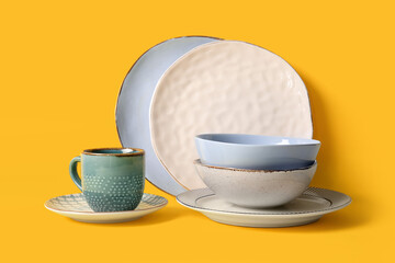 Different tableware on yellow background