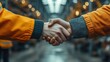 © hugy - Two workers handshake  in an Factory setting