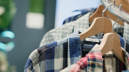 Wall Mural - Zoom in shot on cheap and sustainable clothing from zero waste shopping outlet saving clothes from reaching landfill. Close up shot of elegant men shirts in eco friendly second hand store