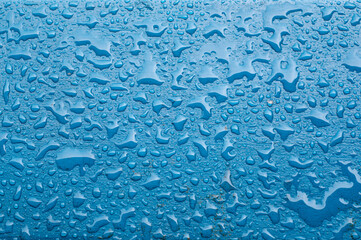 Raindrops on a blue background after heavy rain