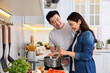 © New Africa - Happy lovely couple cooking together in kitchen