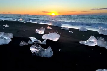 Canvas Print - Icebergs on a black sand beach at sunset, showcasing a beautiful interplay of colors and textures in nature.