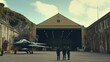 © Iswanto - Three individuals stand in front of a military hangar with an aircraft nearby.
