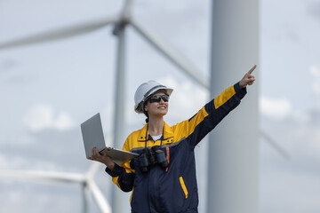 Fototapete - Female engineer wind turbine worker survey operational planning windmill clean renewable energy technology for future. Alternative technology protect environment reduce global warming problems.