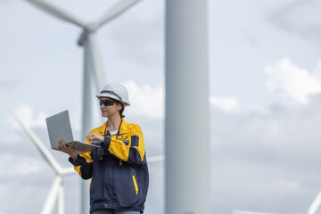 Fototapete - Female engineer wind turbine worker survey operational planning windmill clean renewable energy technology for future. Alternative technology protect environment reduce global warming problems.