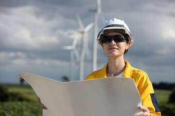 Fototapete - Female engineer wind turbine worker survey operational planning windmill clean renewable energy technology for future. Alternative technology protect environment reduce global warming problems.