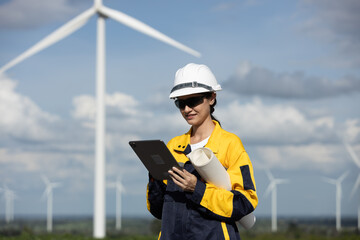 Fototapete - Female engineer wind turbine worker survey operational planning windmill clean renewable energy technology for future. Alternative technology protect environment reduce global warming problems.