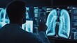 © AUNTYANN STUDIO - A healthcare professional is examining chest radiograph images, likely for diagnostic purposes, on digital screens in a darkened medical imaging room.