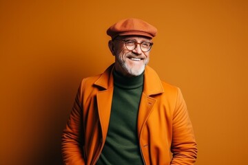 Wall Mural - Portrait of a smiling senior man in a beret and coat.