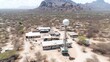 © Iswanto - Aerial view of a remote facility with a communication tower in a dry landscape.
