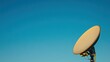 © Iswanto - A satellite dish against a clear blue sky.