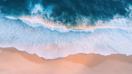 Aerial View of Ocean Waves Crashing on Sandy Beach
