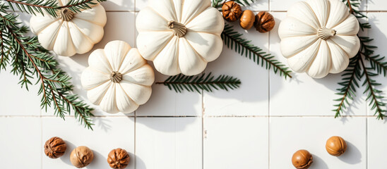 Poster - White Pumpkins and Nuts on a White Tile Background